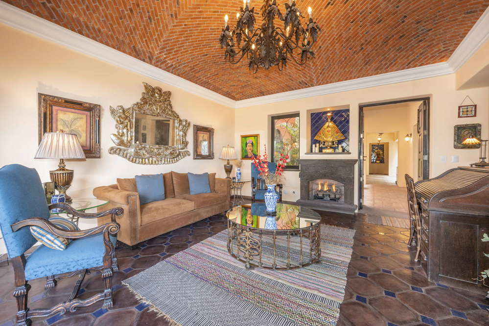 El Obraje main floor, living room, fireplace and boveda ceilings plus two handmade iron chandeliers 2